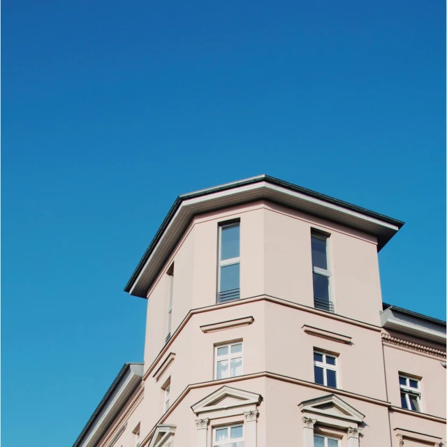 a building with some windows next to a street sign