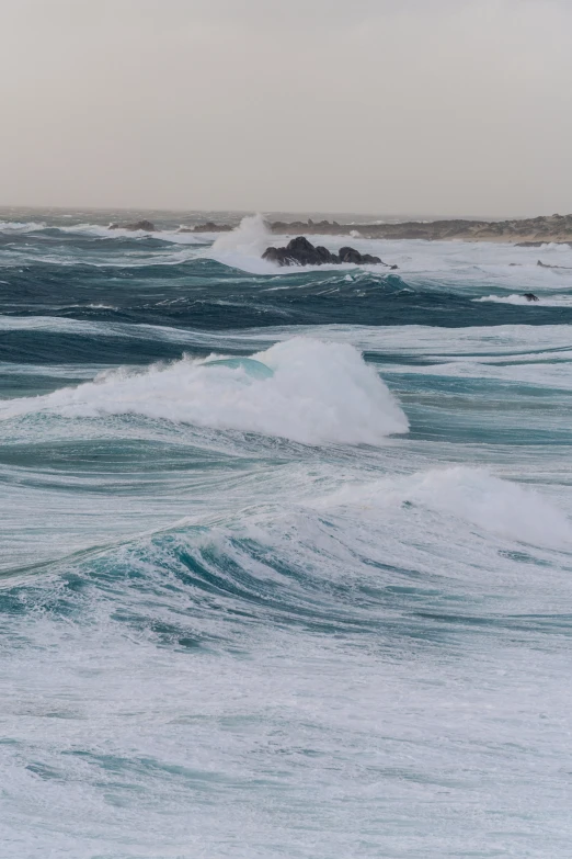 a surfer rides waves in the water near an island