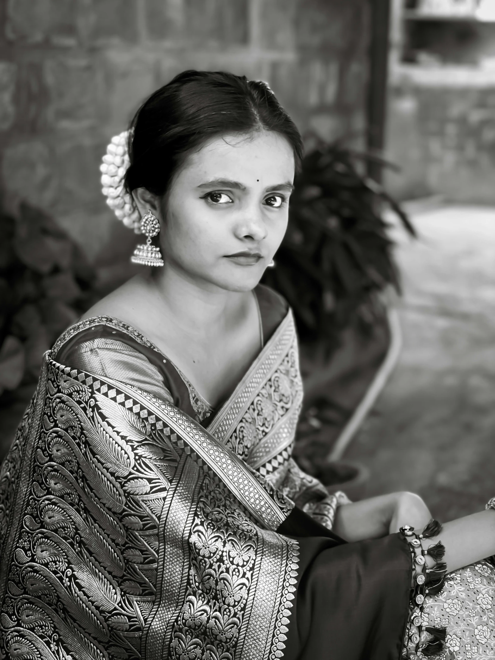 a woman is posing in a traditional dress