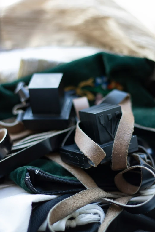 several pieces of leather are sitting on a bed