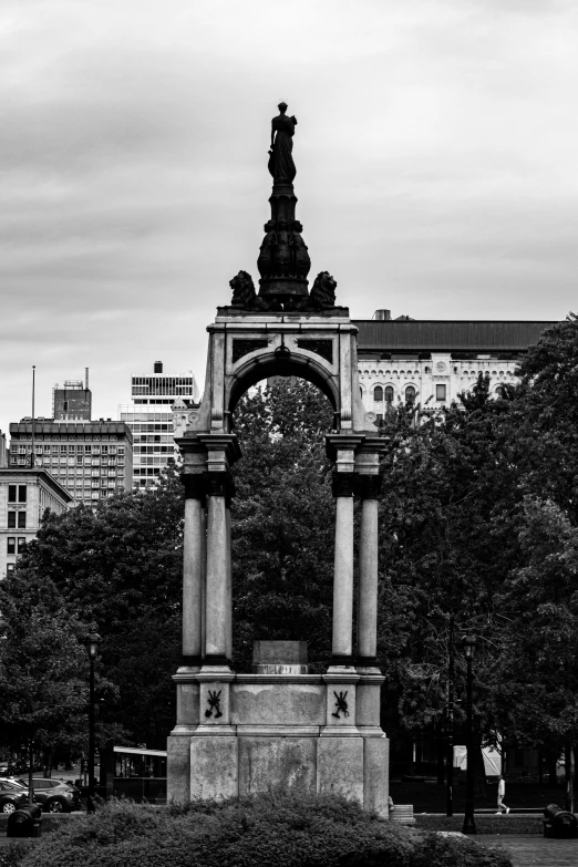 a black and white image of a stone statue