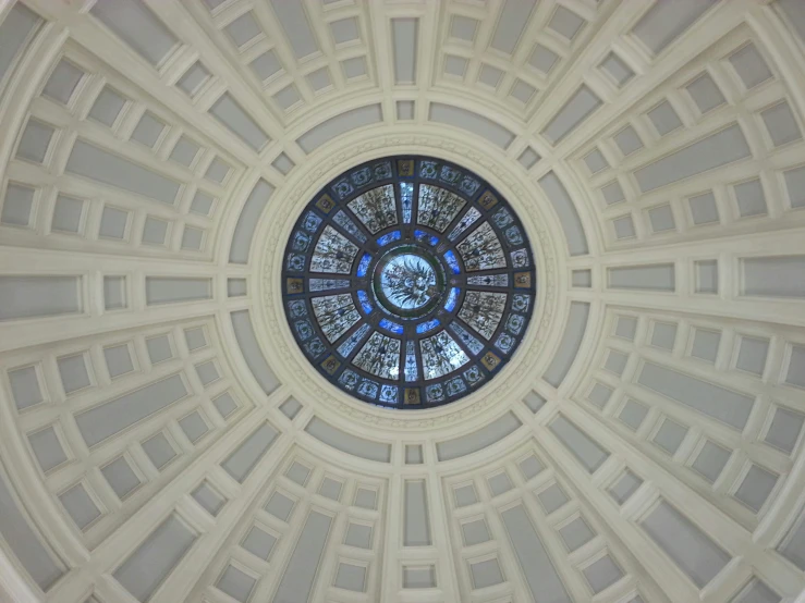 a circular stained glass window with a floral decoration