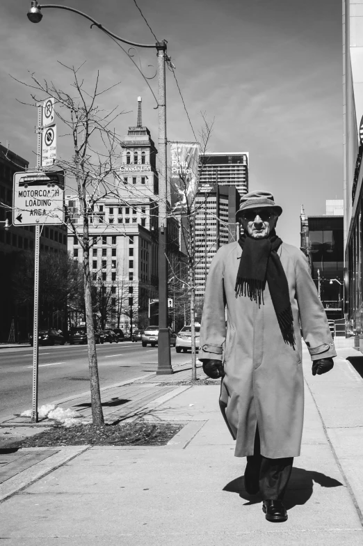 a man walking down the sidewalk next to tall buildings