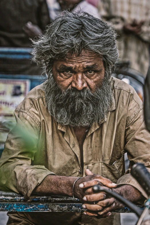 an old man with a beard sitting down