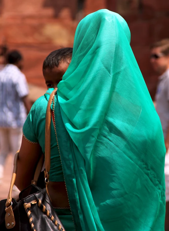 an indian woman walking down the street with her back turned