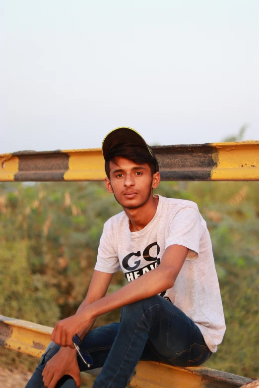 a young man sitting on a yellow boat in the water