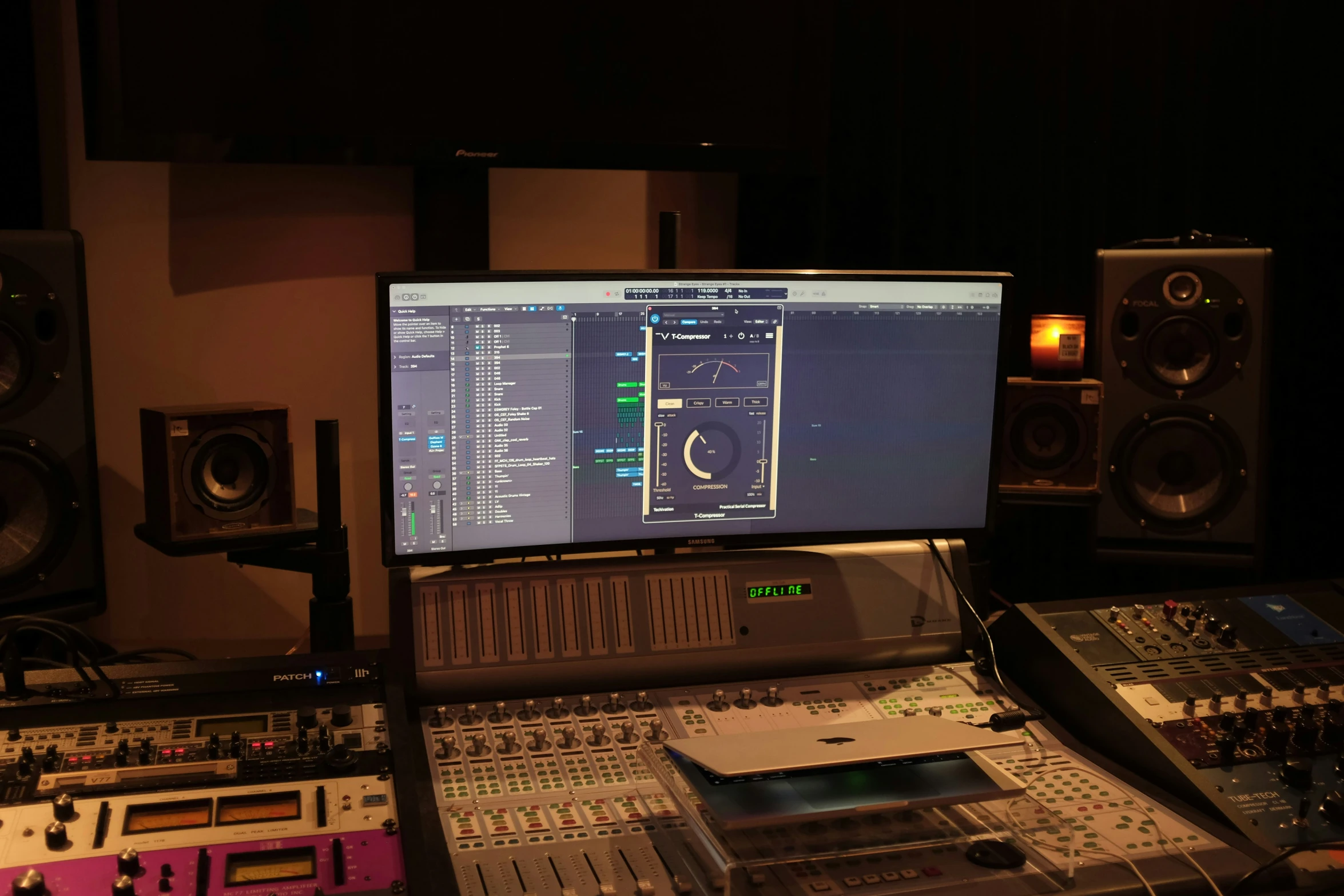 a computer screen and sound board sitting in front of speakers