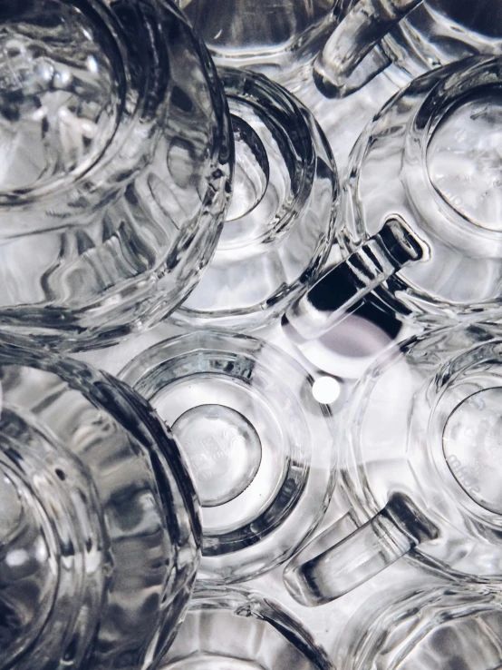 a pile of glass containers filled with black stuff