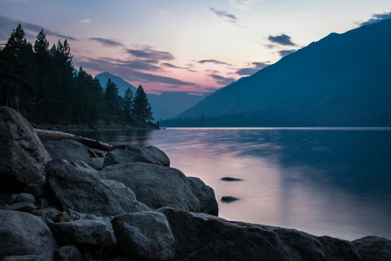 a large body of water next to a rocky shore