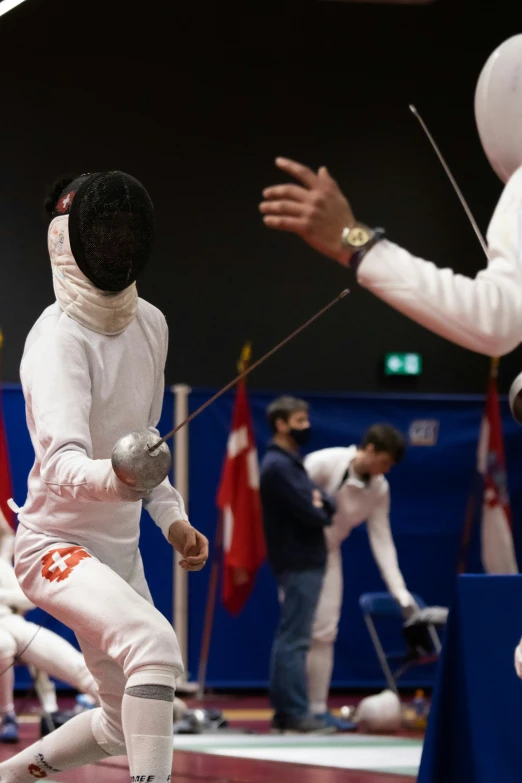 an asian man in fencing gear at the olympics