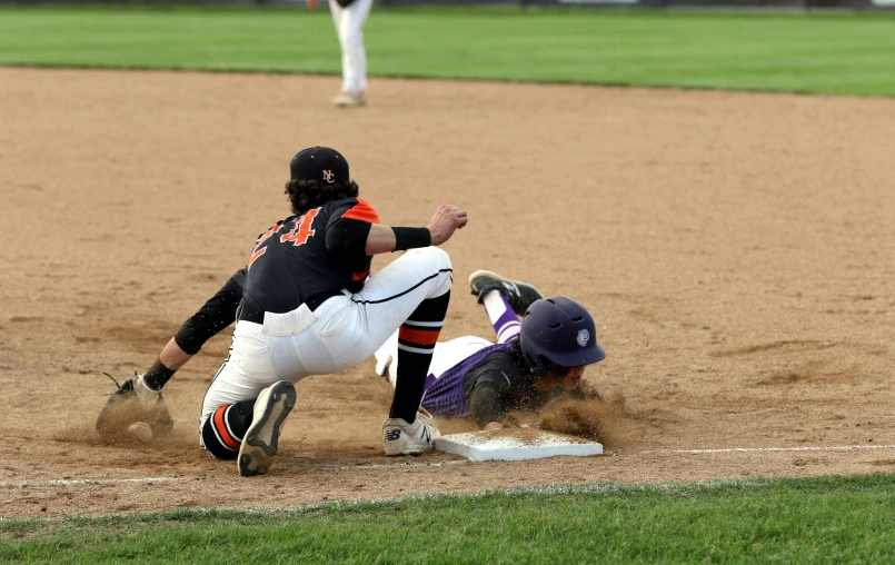 a baseball player sliding into home plate at a game