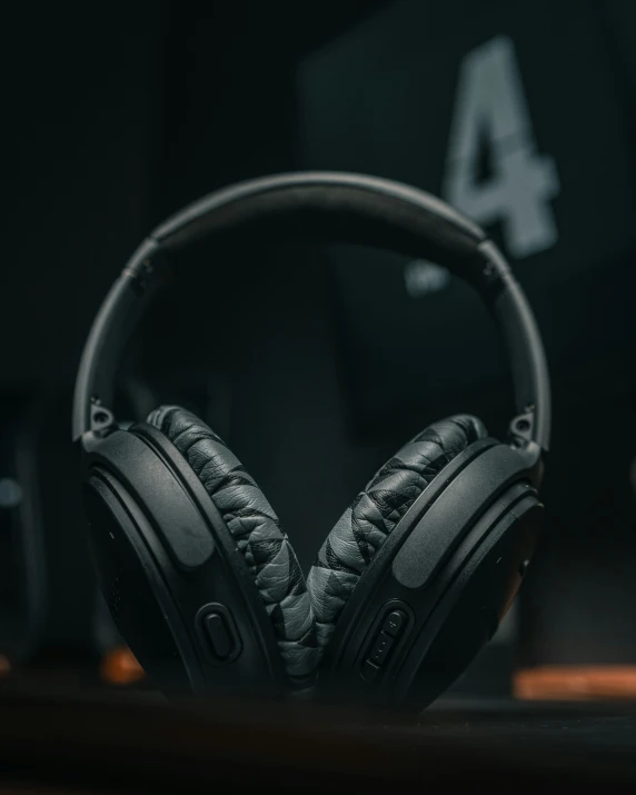 a pair of black headphones sitting on top of a desk