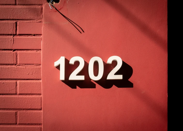 a red wall with the number 1202 below it