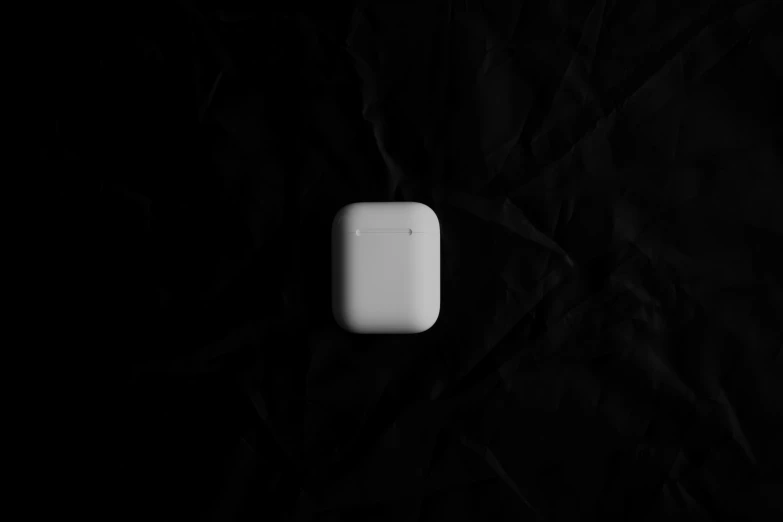 white object on a black background with some material