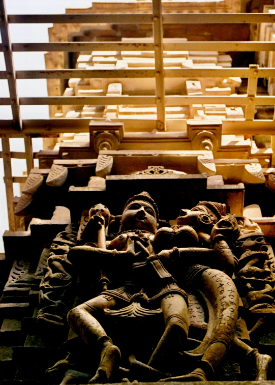 the carved statues in the wooden area are a display