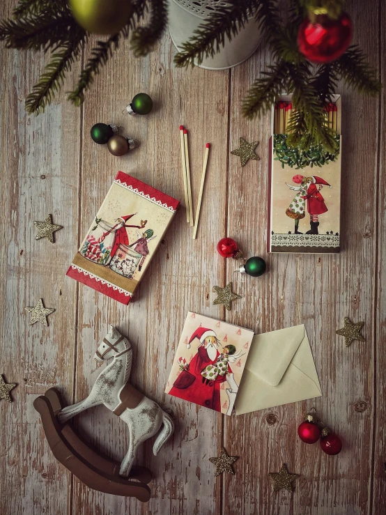 christmas ornaments and card making supplies on a wooden table