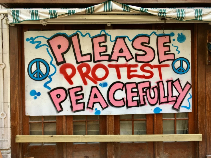 the sign for protest is posted outside of a building