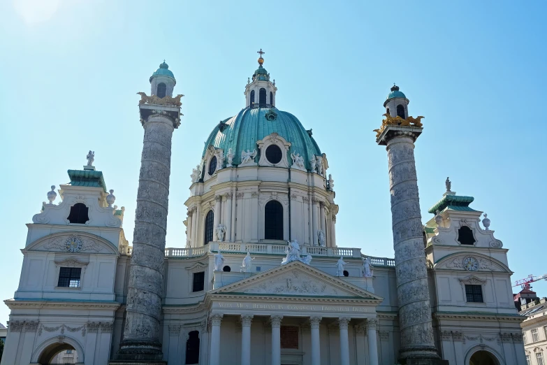 the building is very tall with statues on the front of it