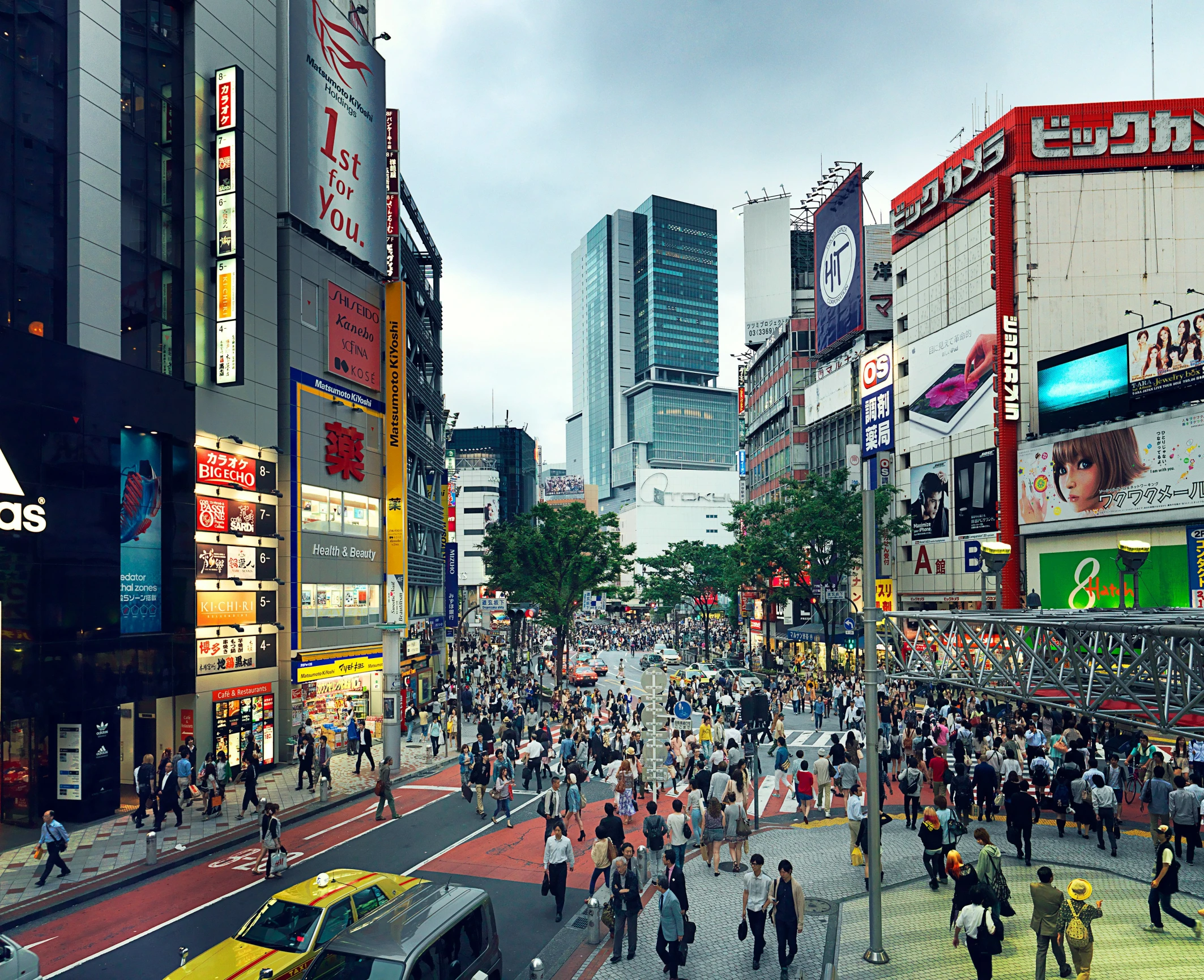 an outdoor scene shows a crowded street during the day