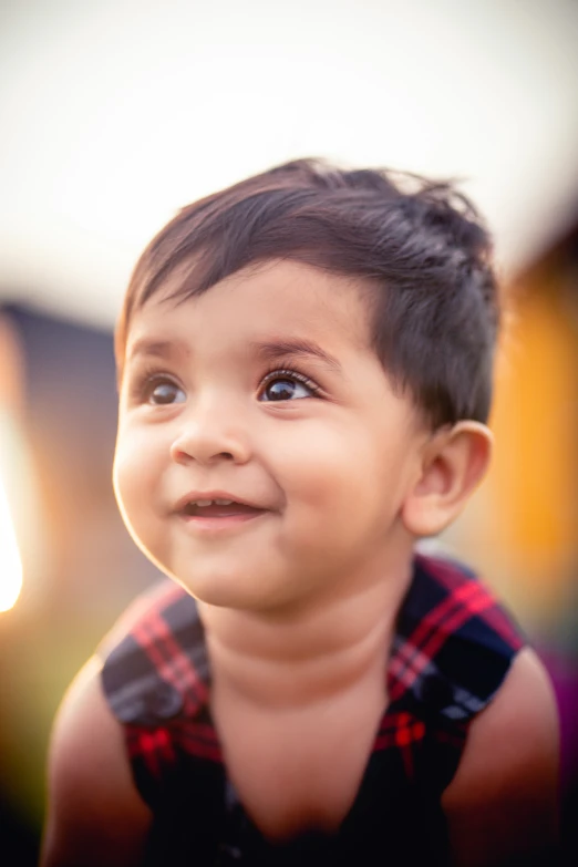 an adorable toddler smiling into the camera