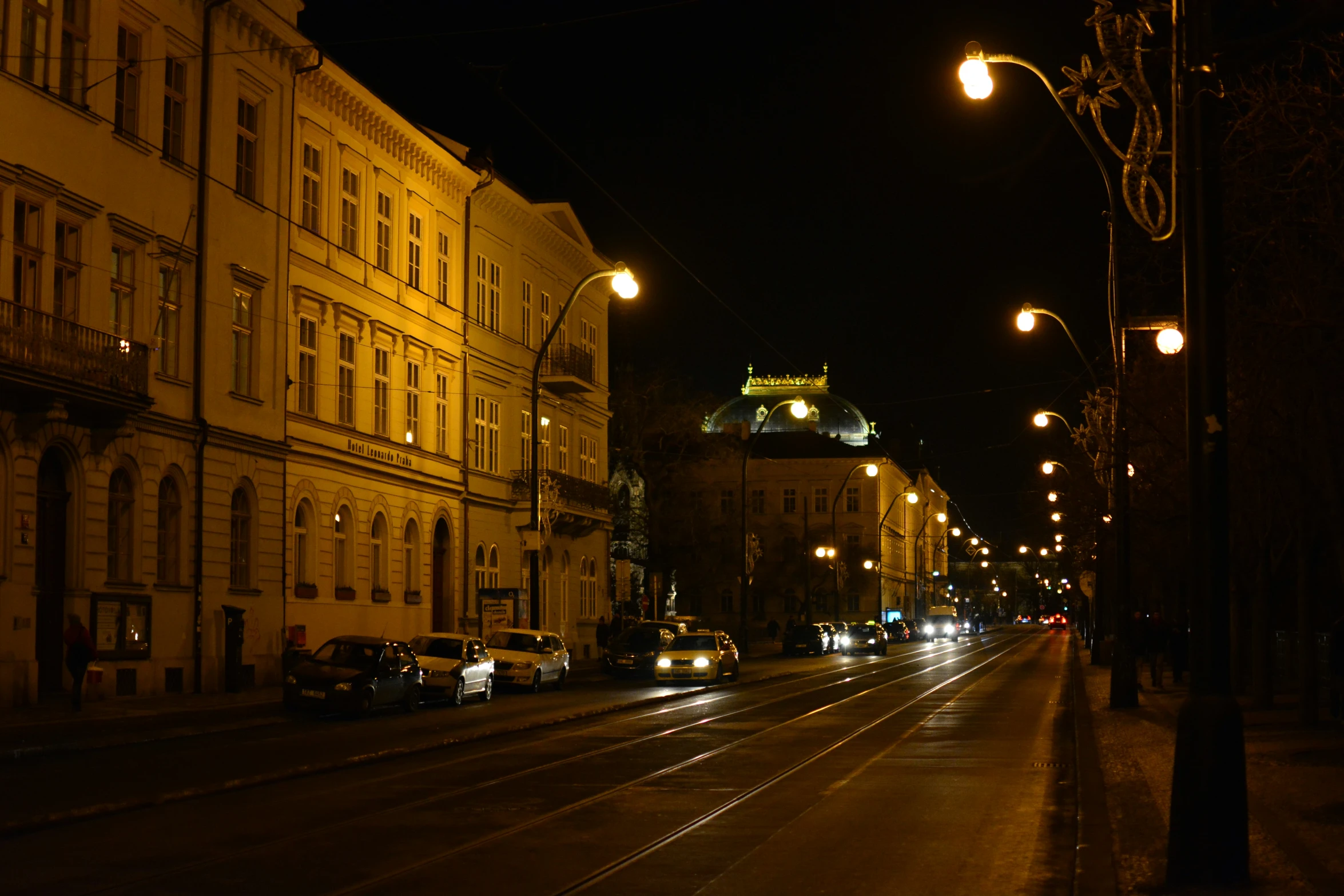 a street that has cars on it by buildings