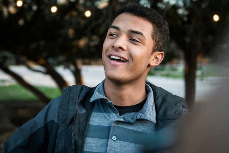 a guy laughing while talking to someone outside