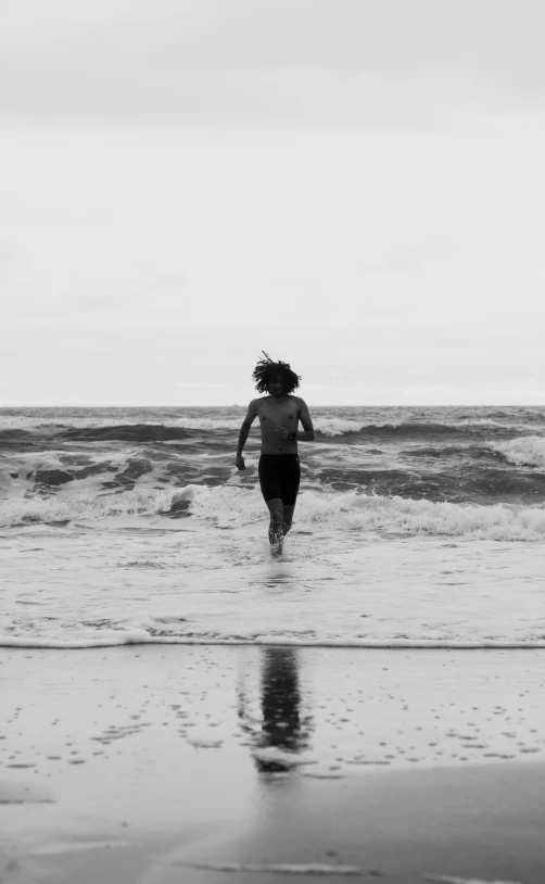 a woman is running through the surf at the beach