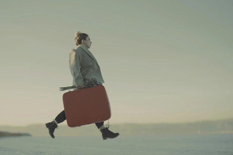 a woman walking across a snow covered field