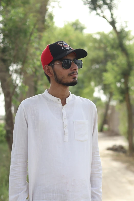 a man in sunglasses and a baseball cap