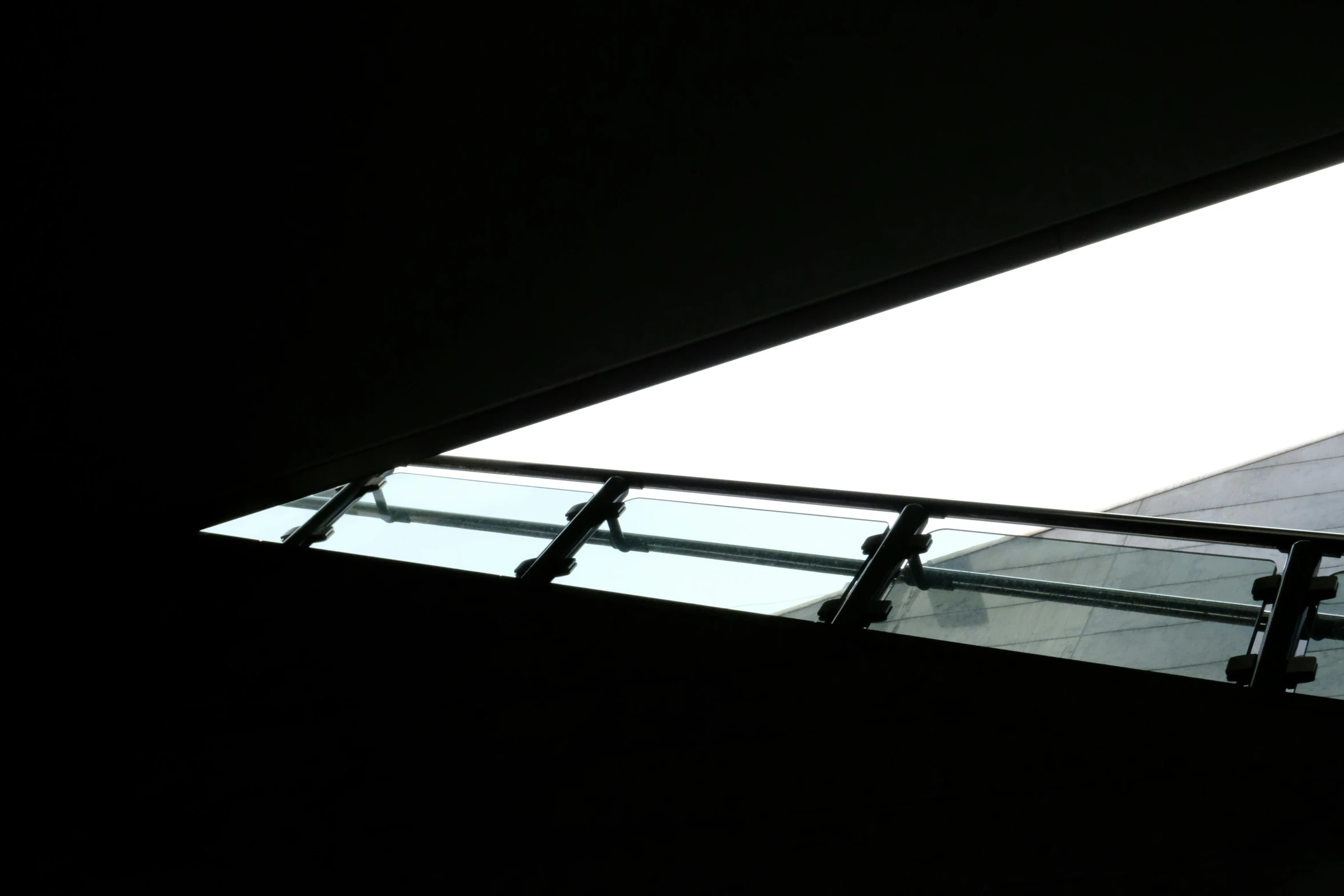 silhouette view of stairway railings and window at top of building