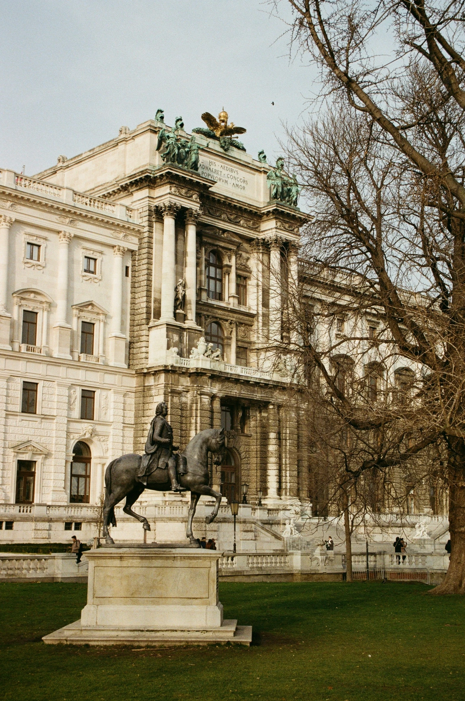 statue of horse and jockey in front of building