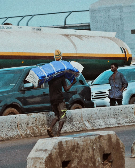 two men who are crossing a street in the rain