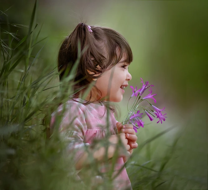 a  holding a purple flower in her hand