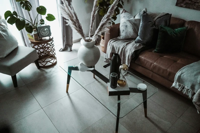 a living room with a couch, coffee table and a vase