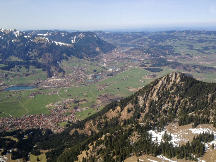 view of a city from above with hills and mountains