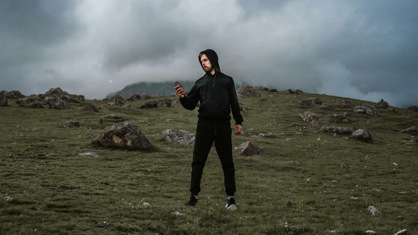 a man standing in a grassy field with a frisbee