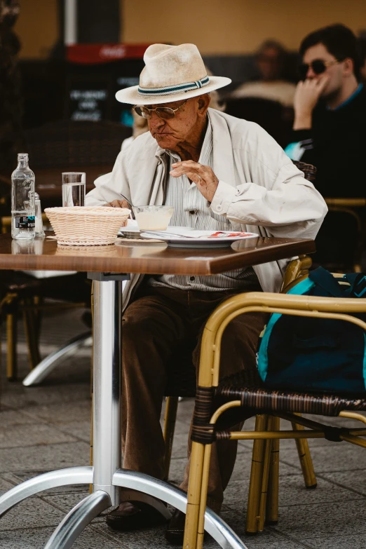 a man sitting at a table eating cake