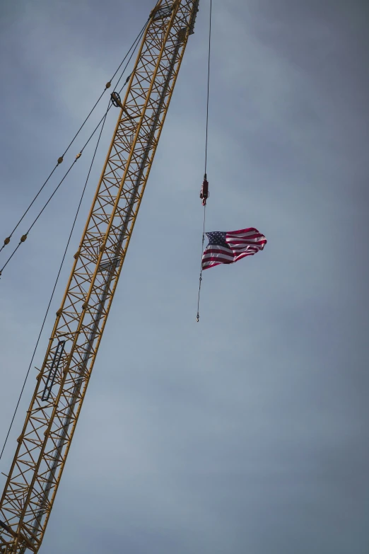 a crane flying with an american flag on it