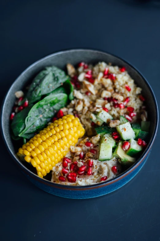 a bowl filled with food and vegetables on a table