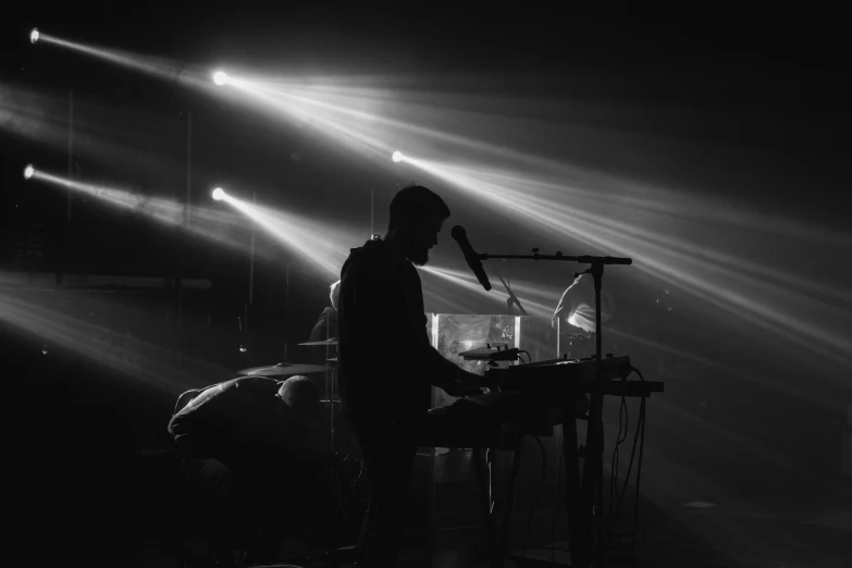 a man with a headphones on in front of stage lights