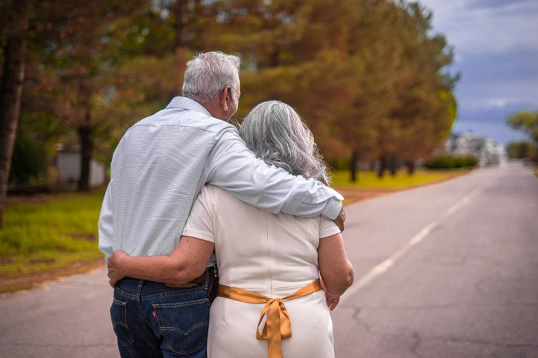 two people are walking down the road together