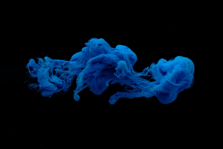 a blue liquid is floating on the water