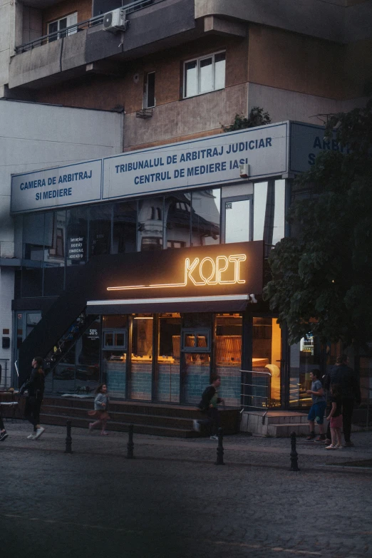 a large building with two rows of windows and an illuminated sign