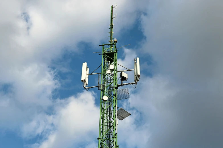 the antenna tower has three radio dishes on it