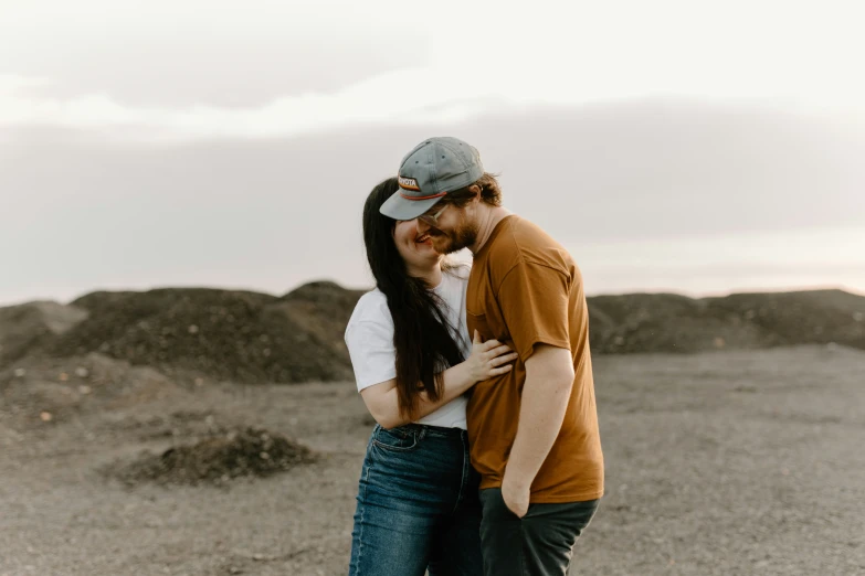 the man is hugging the woman from behind