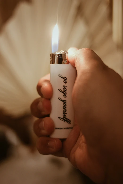 a hand holding a lighter with the word happy birthday on it