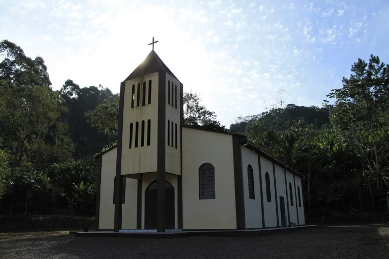 a church with a cross sitting in the top