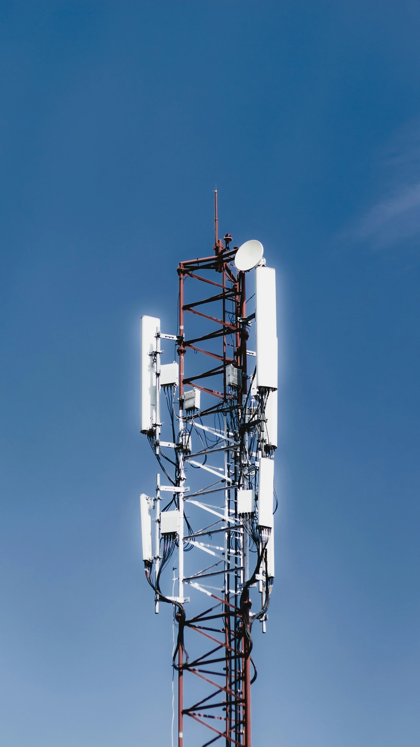 large antenna tower in front of blue sky