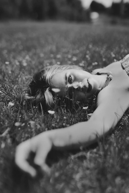 black and white po of woman lying on ground