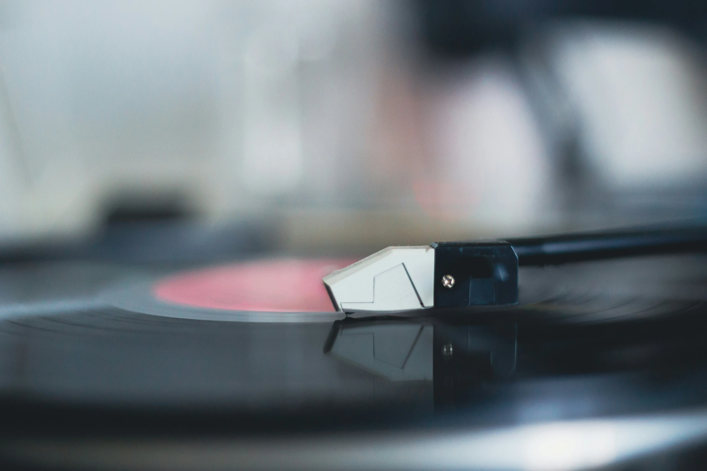 turntable with white disk with black handles and wooden base